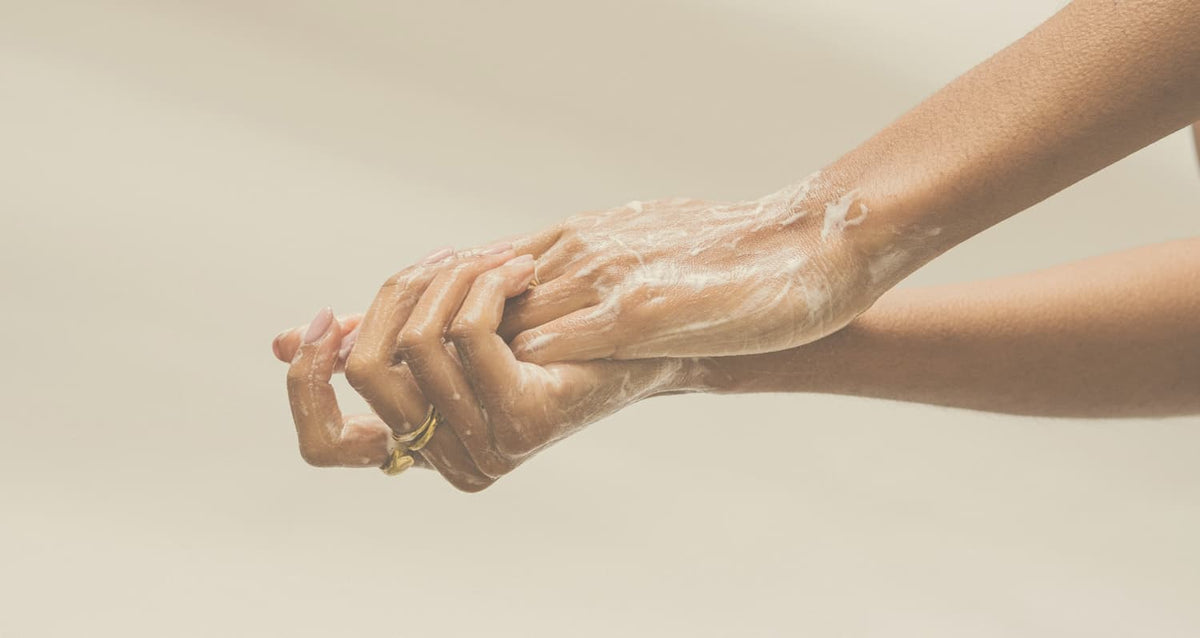Elegant hands rubbing together with soap 
